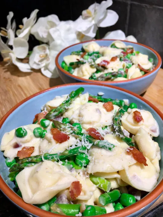 bowls of asparagus bacon and pea tortellini pasta