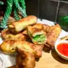 copycat cheesecake factory avocado egg rolls air fried and plated on a wood board