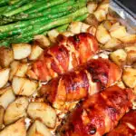 bacon wrapped cheese stuffed bacon plated with asparagus and roasted potatoes