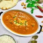 bowl of butter chicken with rice and naan bread