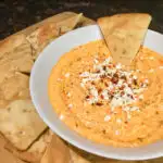 Feta Roasted Red Pepper Dip in a white bowl with pita