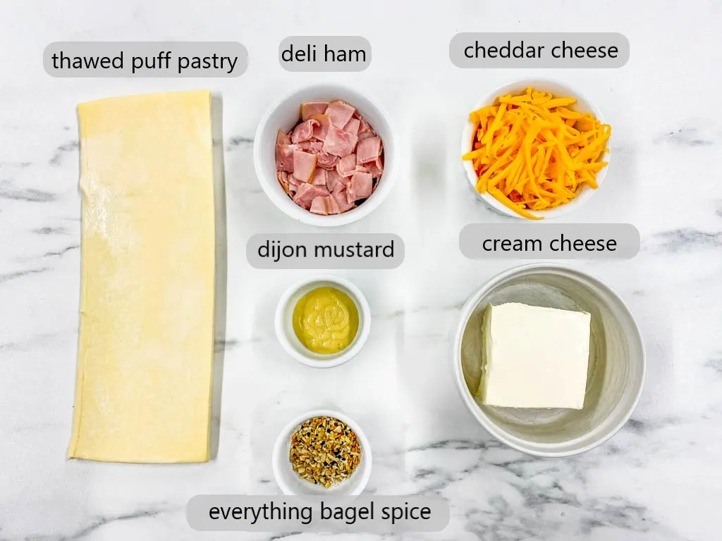 ingredients to make Ham and Cheese Pinwheels on a marble cutting board