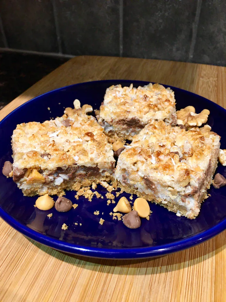 Magic Bars 8 Layer bars on a blue plate