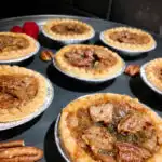 maple pecan butter tarts on a metal plate