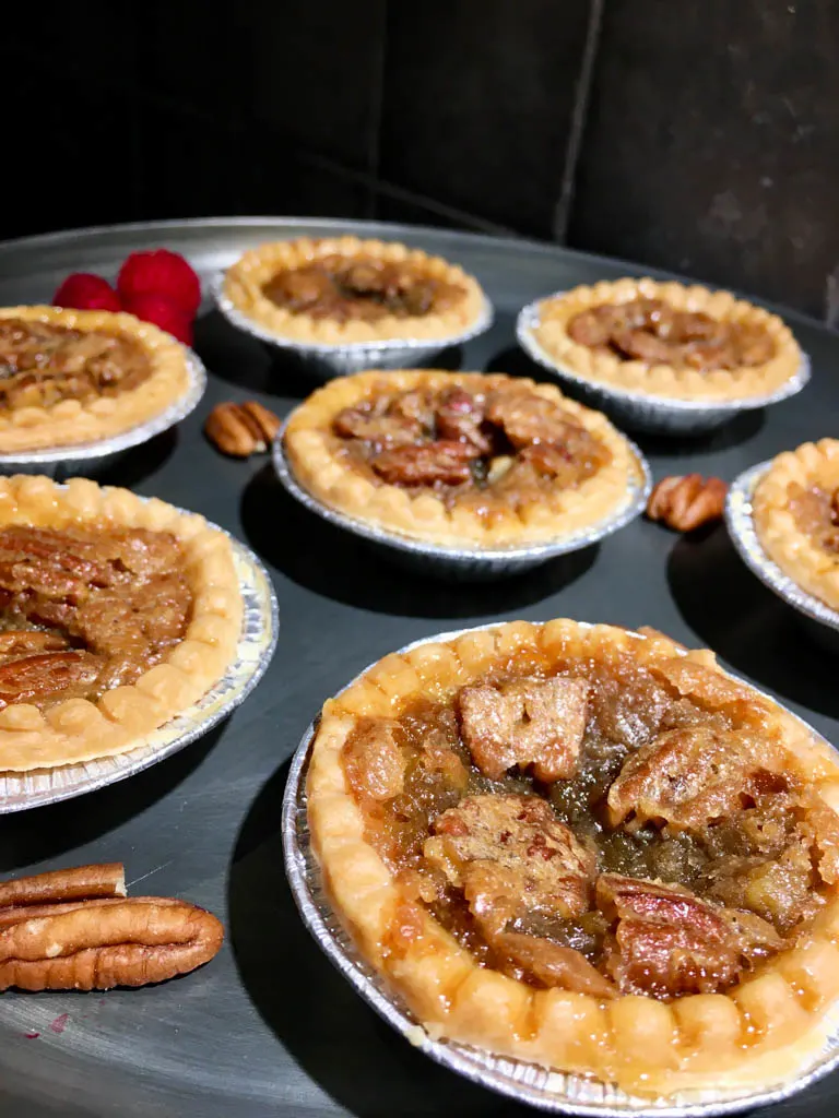 maple pecan butter tarts on a metal plate