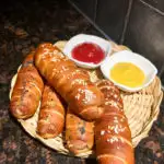 Pretzel Wrapped Hot Dogs plated in wicker plate