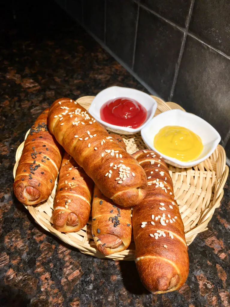 Pretzel Wrapped Hot Dogs plated in wicker plate