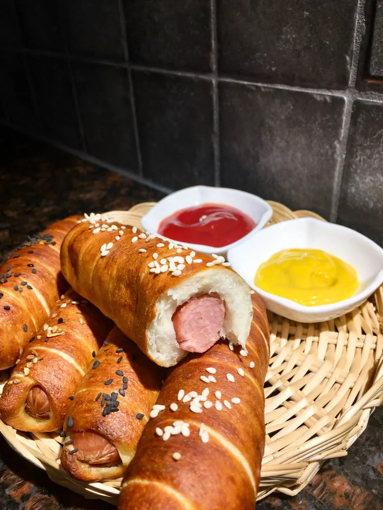 Pretzel Wrapped Hot Dogs plated in wicker plate