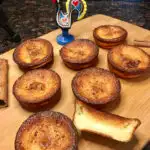 Queijadas de Leite Portugese Tarts plated on a wood board with a rooster