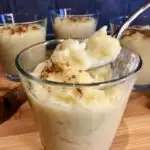 rice pudding in a cup on a wood board