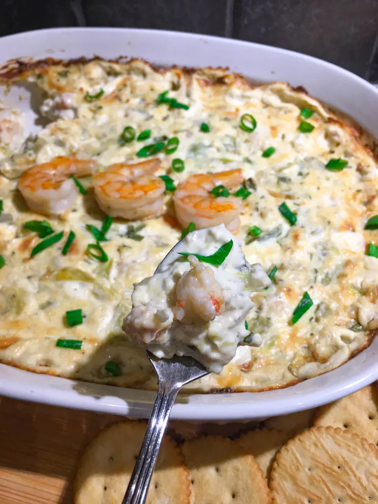 shrimp artichoke dip plated with crackers
