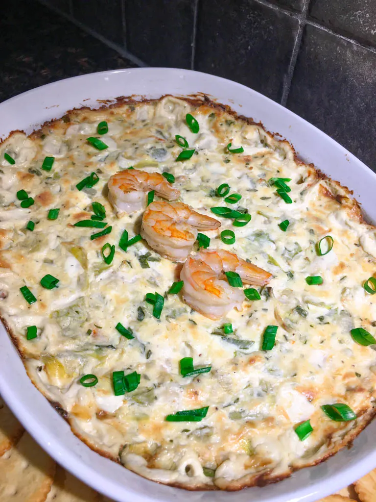 shrimp artichoke dip plated with crackers