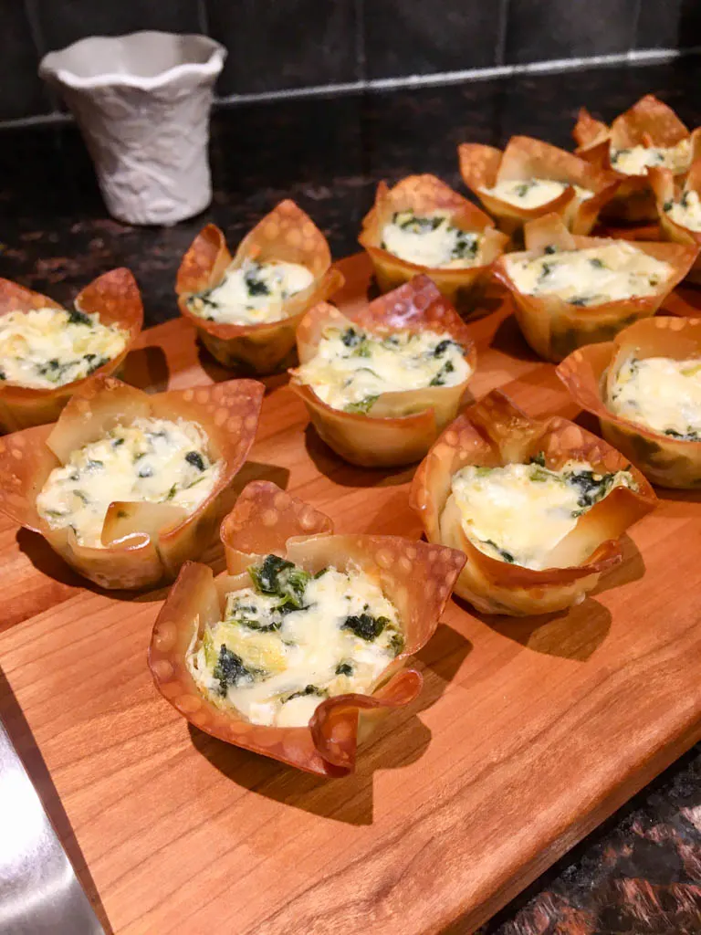 Spinach Artichoke Dip Wonton Cups on a wood board