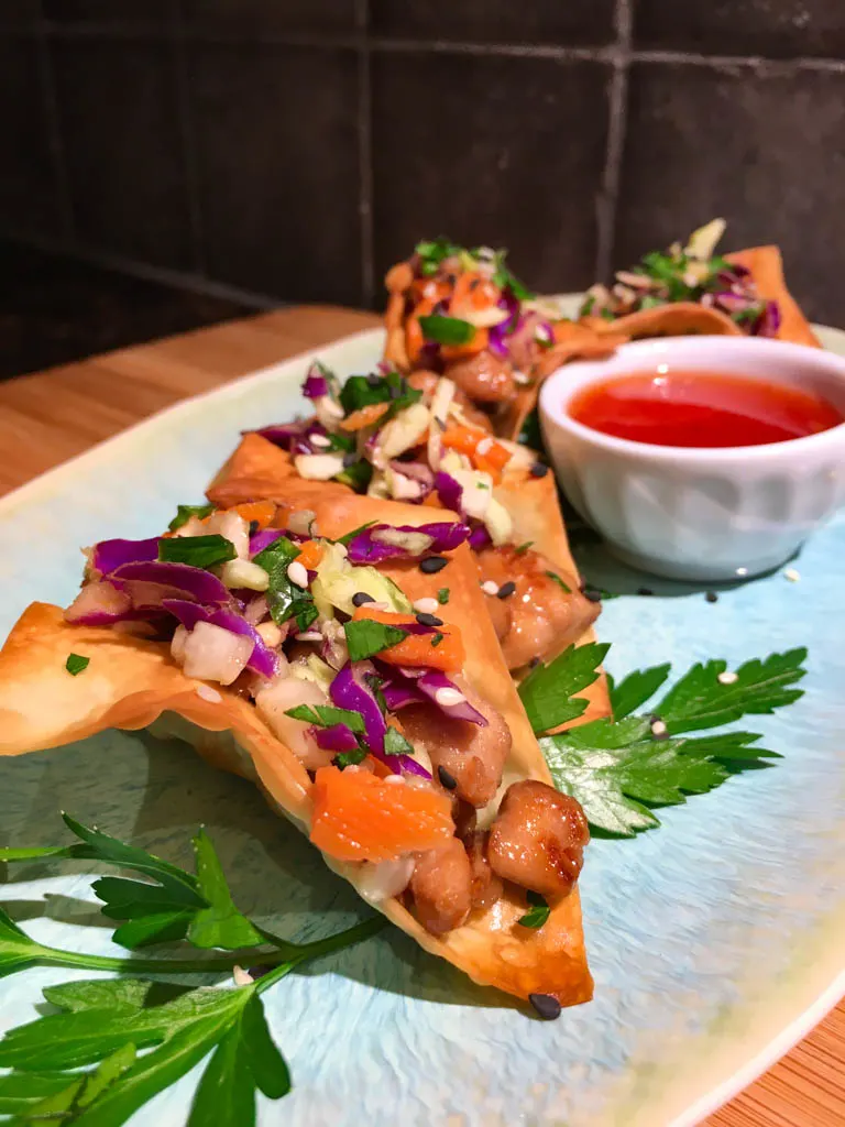 Sweet Chili Chicken Wonton Tacos on a blue plate