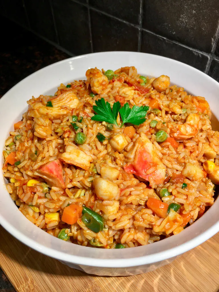 Tomato Seafood Rice Portuguese in a white serving dish