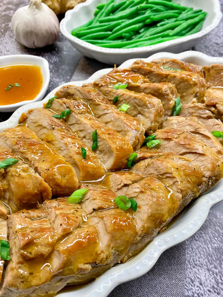 Instant Pot Honey Garlic Pork Tenderloin Recipe The Best sliced and served in a white platter