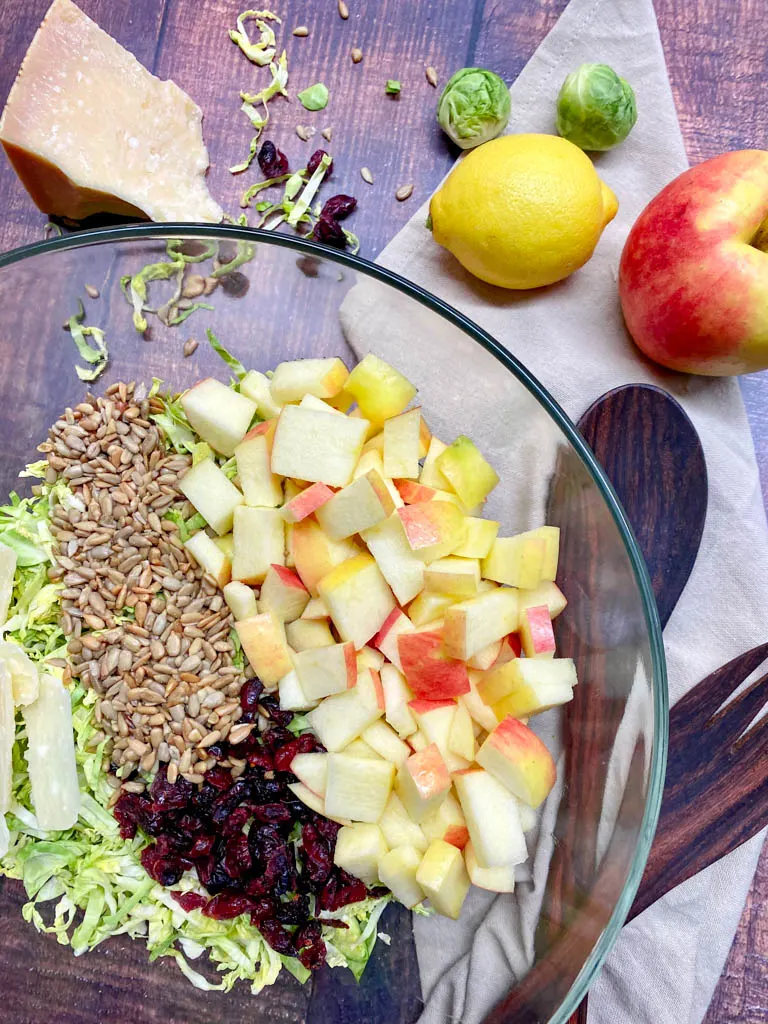 shaved brussels sprout salad in a large glass bowl