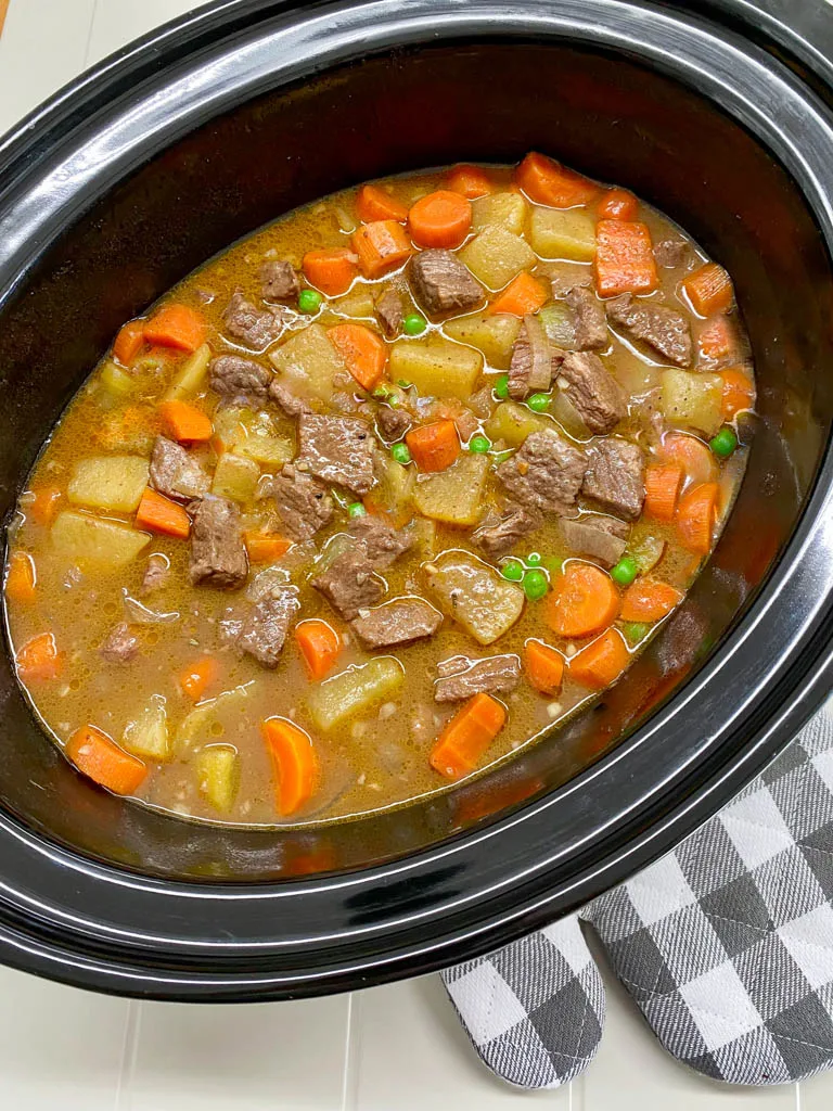 beef stew in a black slow cooker