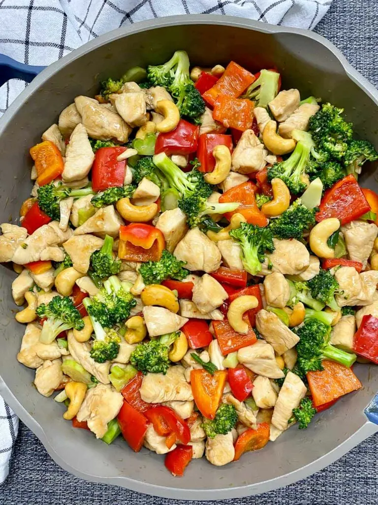 cashew chicken stir fry in a gray frying pan