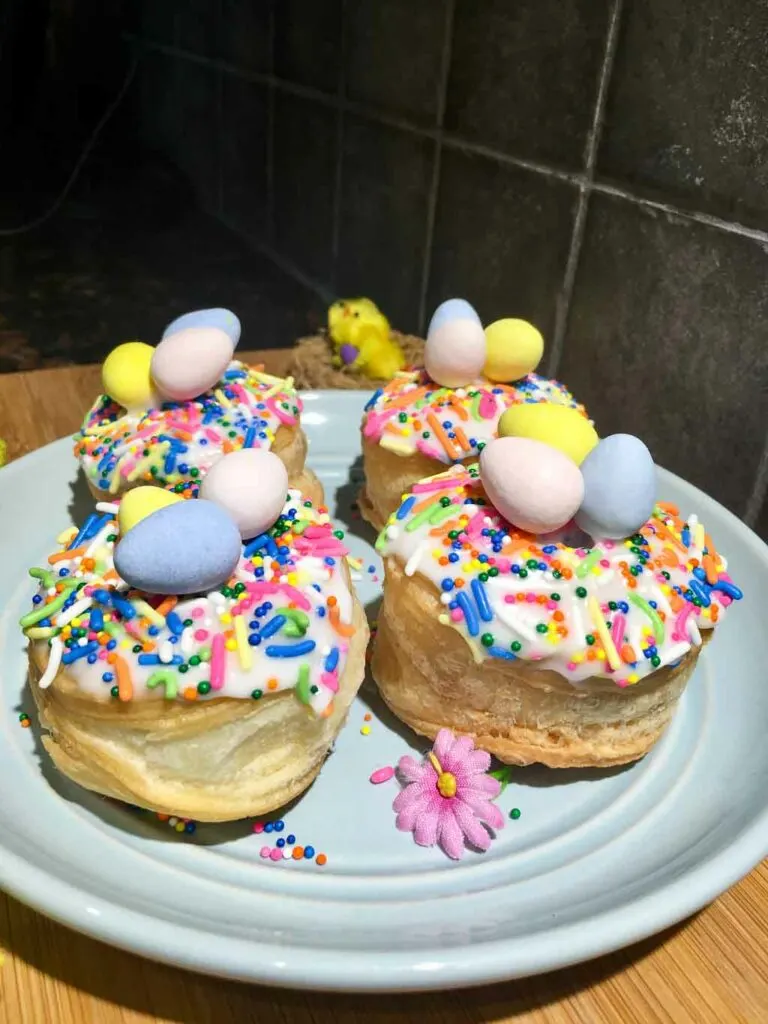 easter donuts on a blue plate and wood board