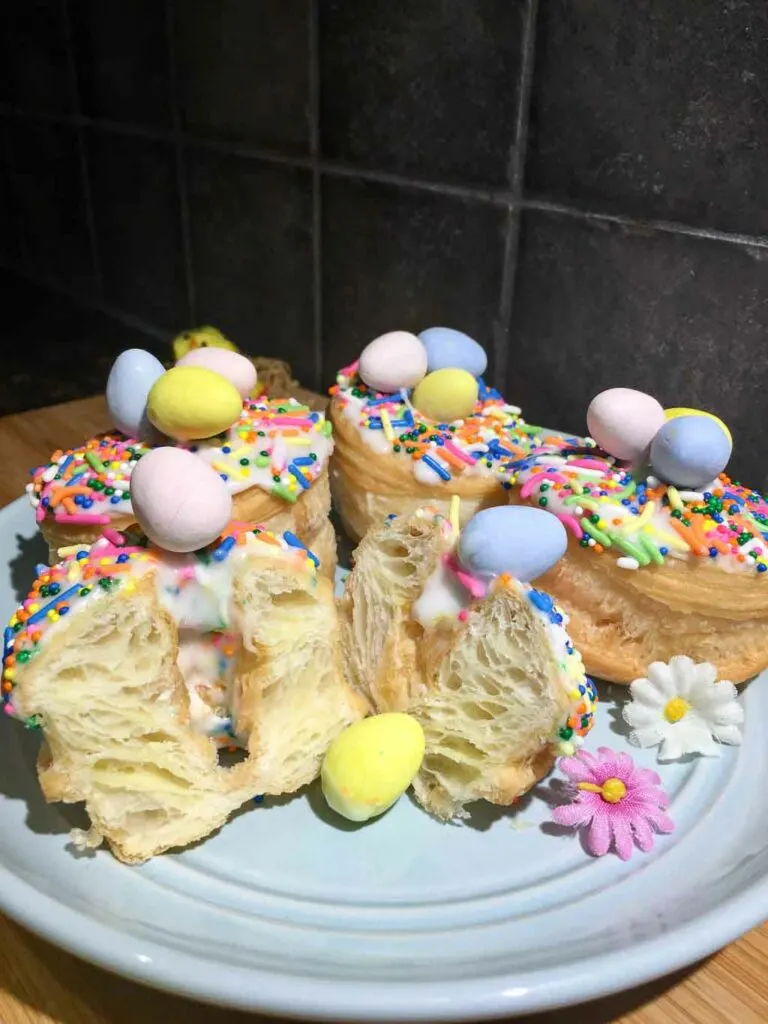 easter donuts on a blue plate and wood board