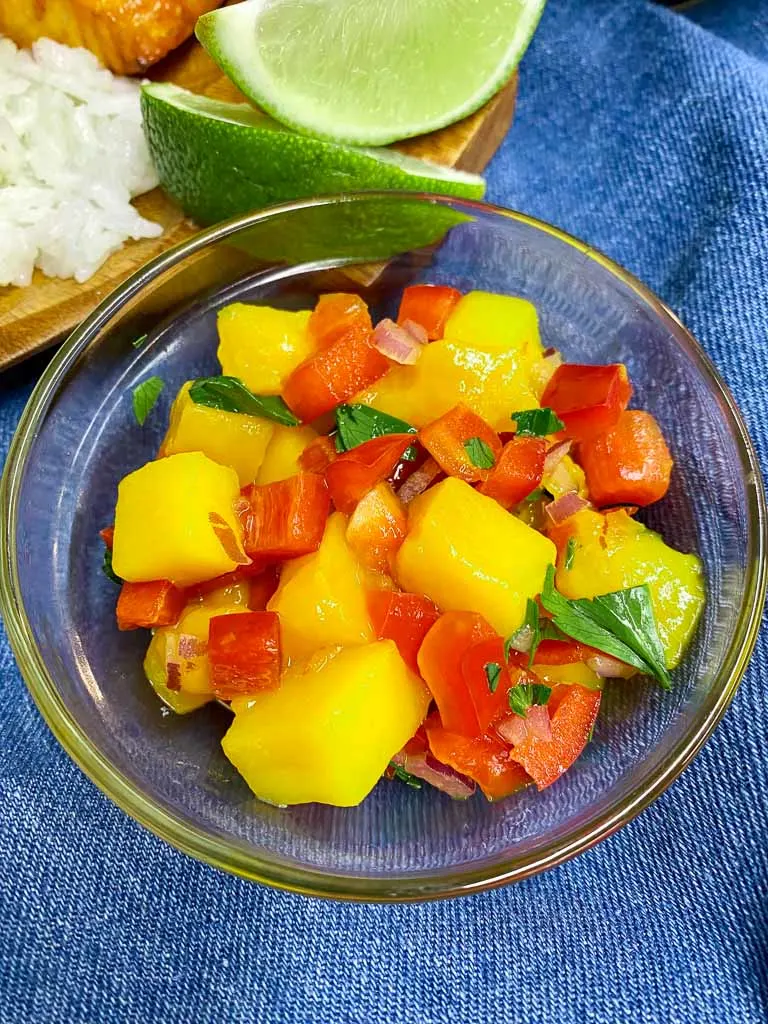 mango salsa in a bowl on a blue towel