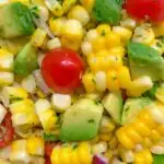 close up image of avocado corn tomato salad