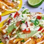 chicken tinga tostadas garnished with cotija cheese and cilantro