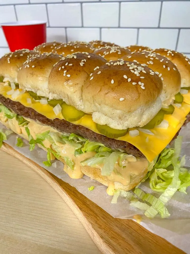 Big Mac sliders on a wood board with parchment paper