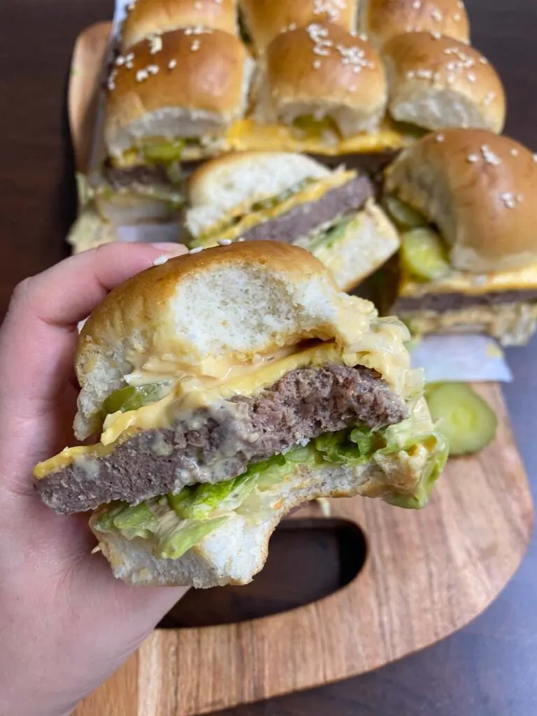 Big Mac sliders on a wood board with parchment paper