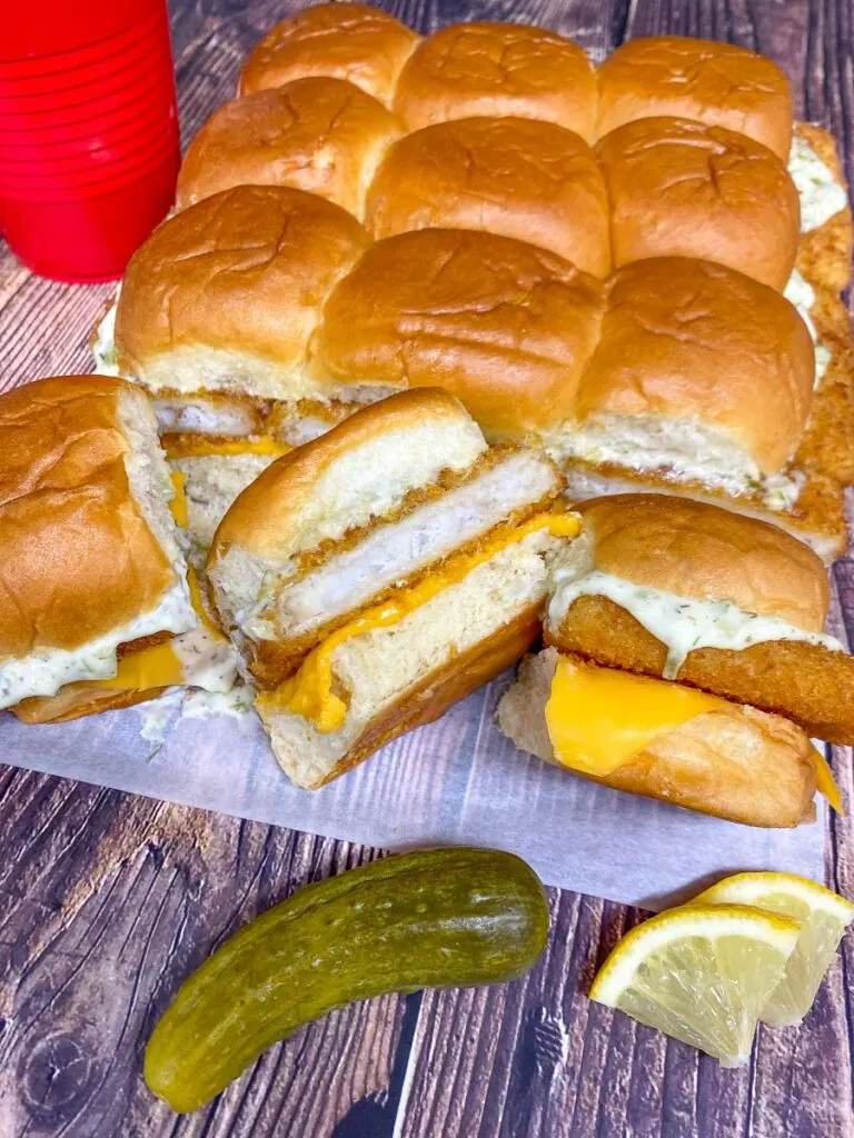 filet-o-fish sliders on a white paper with cheese and tartar sauce