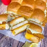 filet-o-fish sliders on a white paper with cheese and tartar sauce