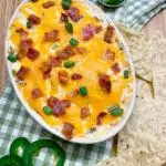 jalapeno popper chicken dip with tortilla chips on the side