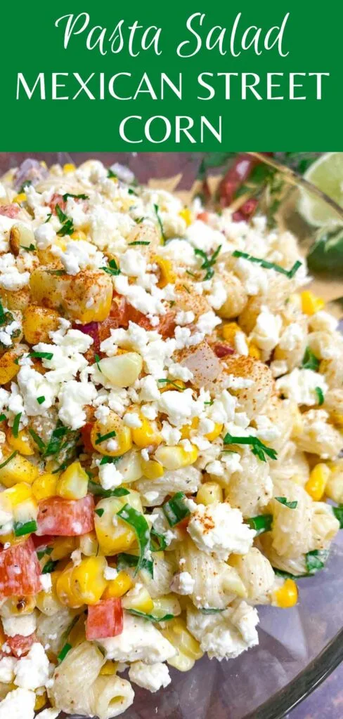 Mexican street corn pasta salad in a glass bowl garnished with jalapeno and cotija cheese