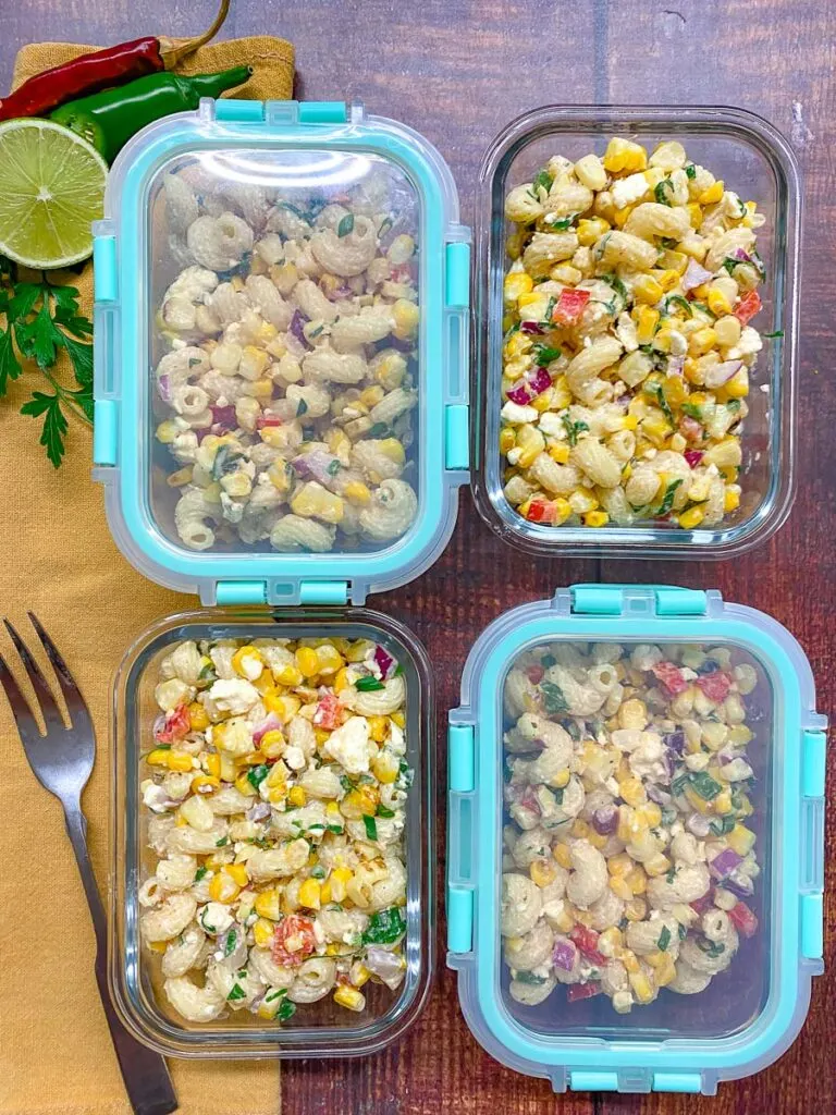 glass meal prep containers filled with Mexican street corn pasta salad