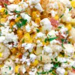 Mexican street corn pasta salad garnished with cotija cheese