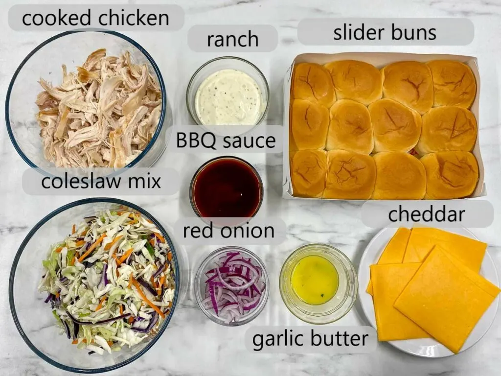 bowls with cooked chicken, coleslaw mix, ranch, BBQ sauce, red onion, slider buns, garlic butter, cheddar to make bbq chicken sliders