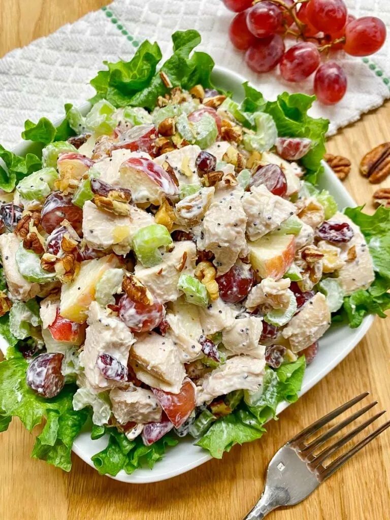 chicken waldorf salad plated on a bed of lettuce