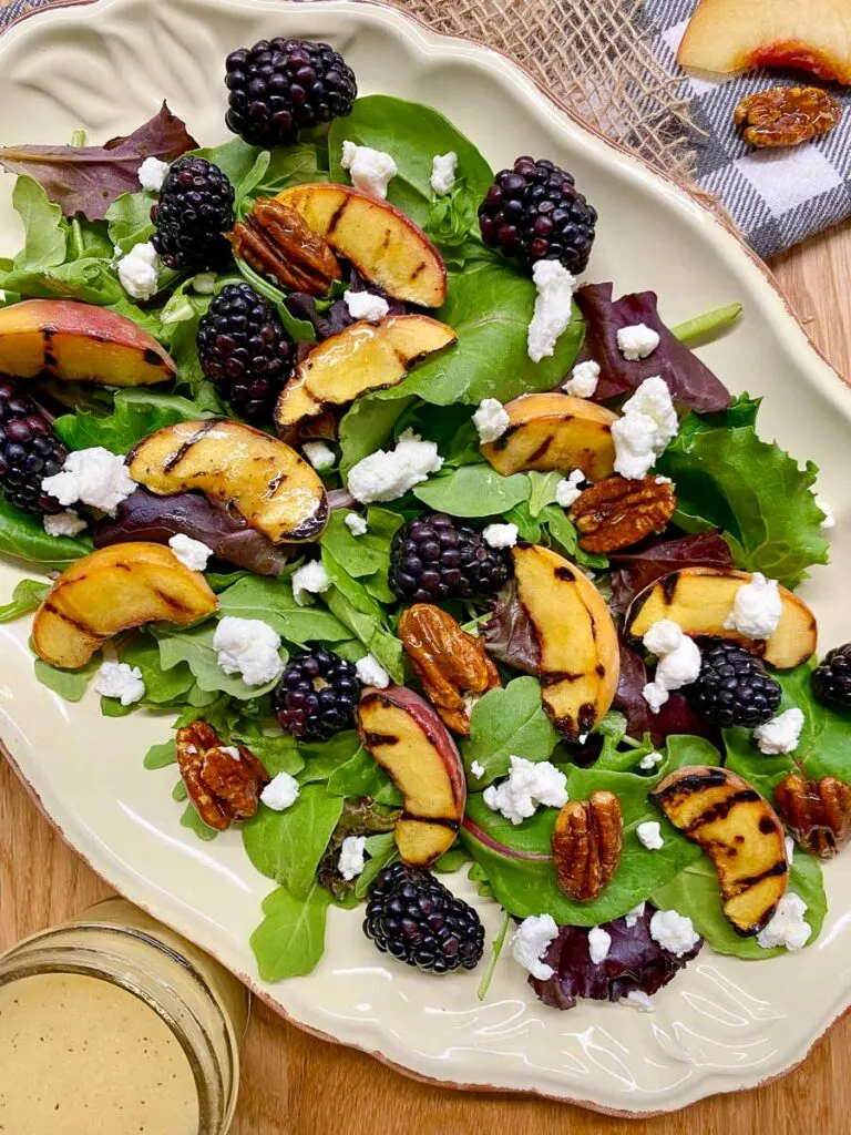 grilled peach blackberry salad on a platter