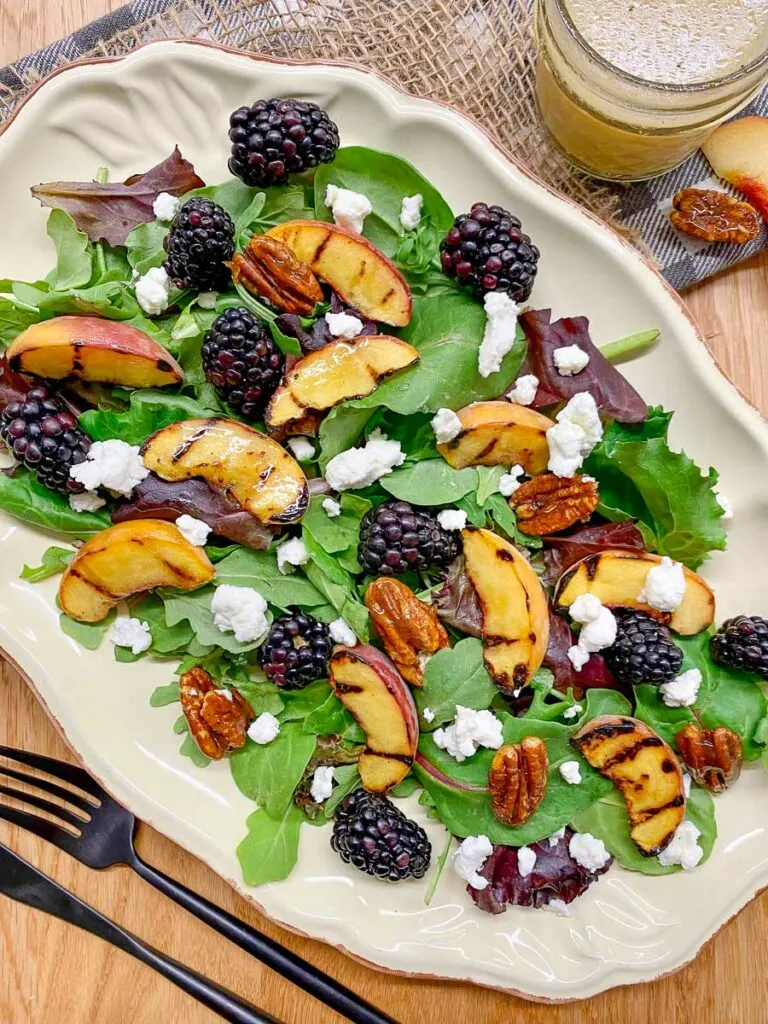 grilled peach blackberry salad on a platter