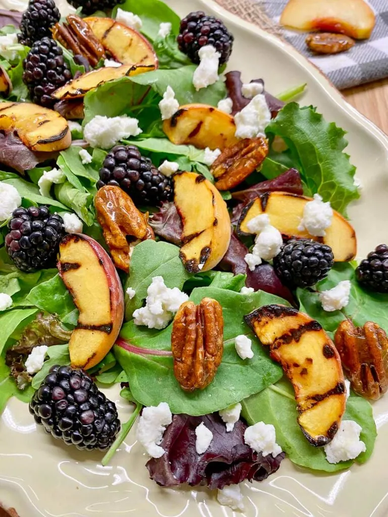 grilled peach blackberry salad on a platter