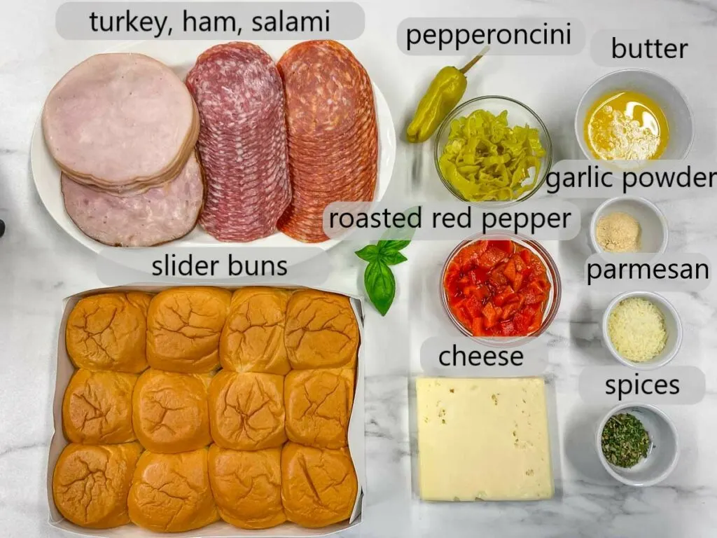 bowls with deli turkey, ham, salami, pepperoncini, butter, roasted red pepper, garlic powder, parmesan, spices, cheese and slider buns to make Italian sliders