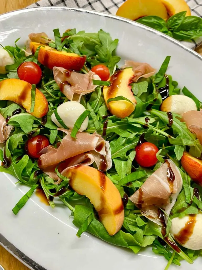 peach caprese salad on a platter