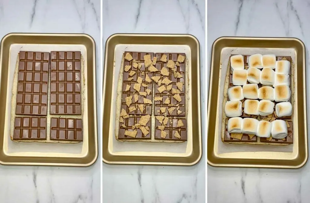 adding chocolate, graham crackers and marshmallows on sliders to make s'mores sliders on a sheet pan