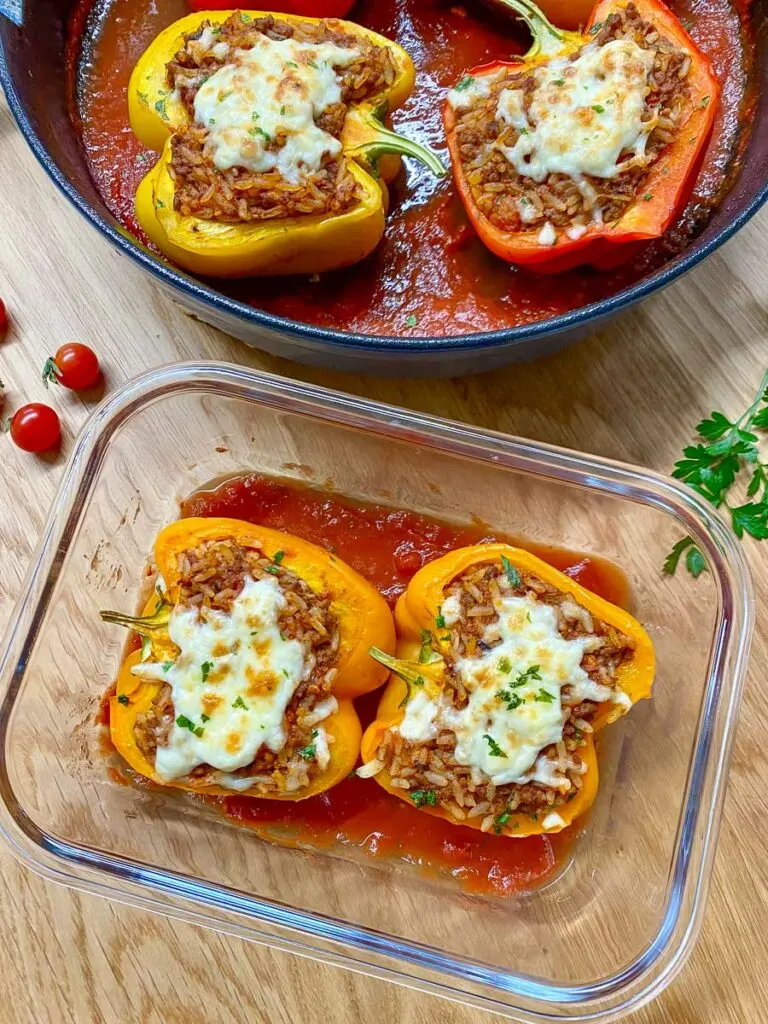 stuffed peppers in a cast iron skillet and glass container