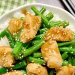 bowl of honey garlic chicken and green beans with rice and sesame seeds