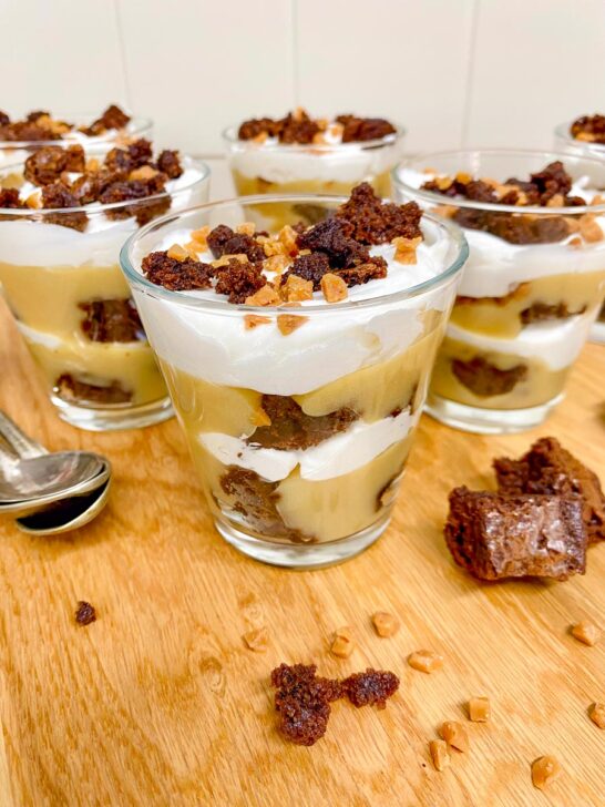 mocha brown trifles in glass cups on a wood counter