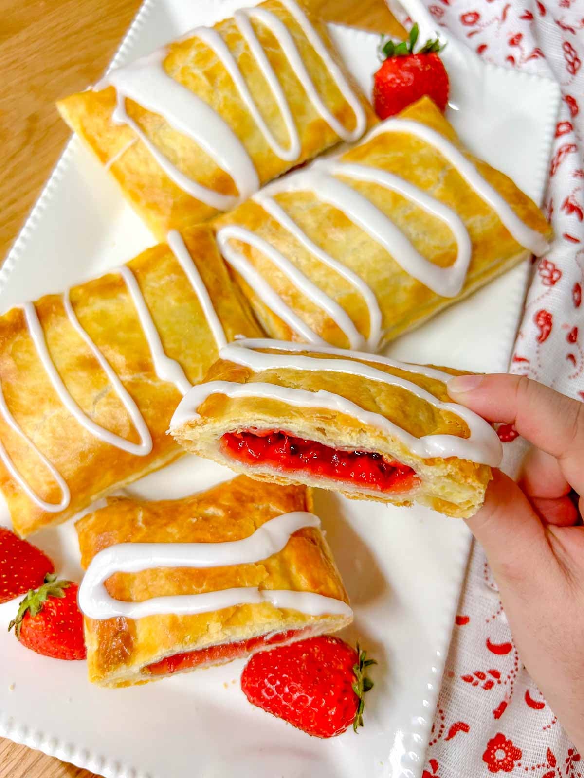 one half of a homemade toaster strudel is held close to the camera