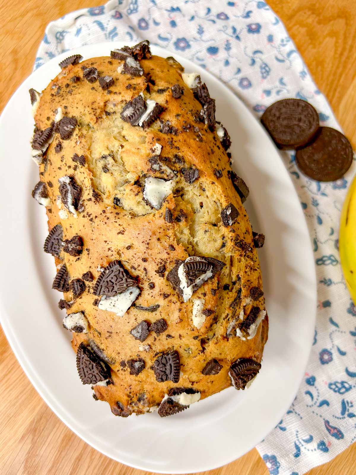a loaf of Oreo banana bread is on a white serving platter