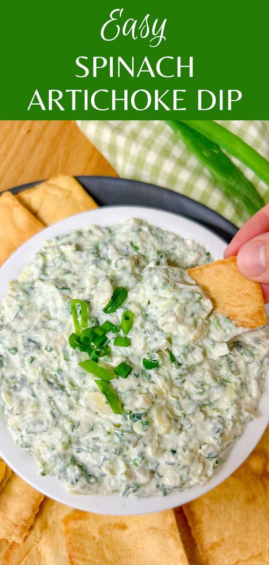 a black plate has a white serving bowl with spinach artichoke dip in it and pita chips around the bowl. text overlay has the recipe name 'easy spinach artichoke dip'